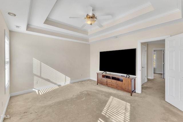 living room with a raised ceiling, crown molding, ceiling fan, and light colored carpet