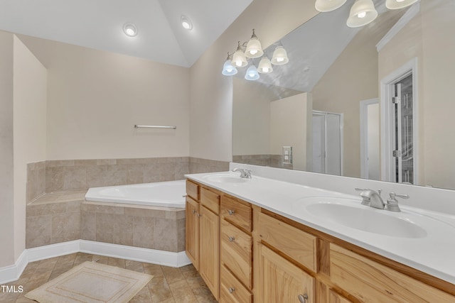 bathroom featuring vanity, vaulted ceiling, tile patterned flooring, a relaxing tiled tub, and a notable chandelier