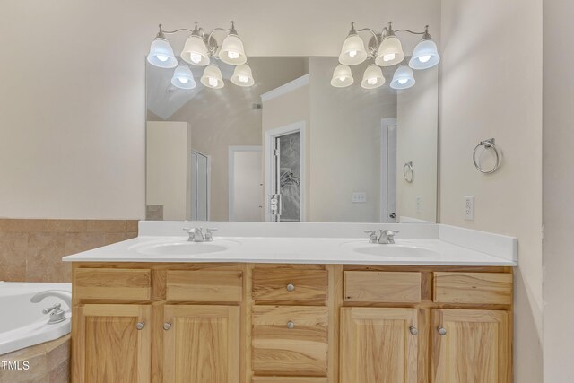 bathroom with vanity, an inviting chandelier, and separate shower and tub