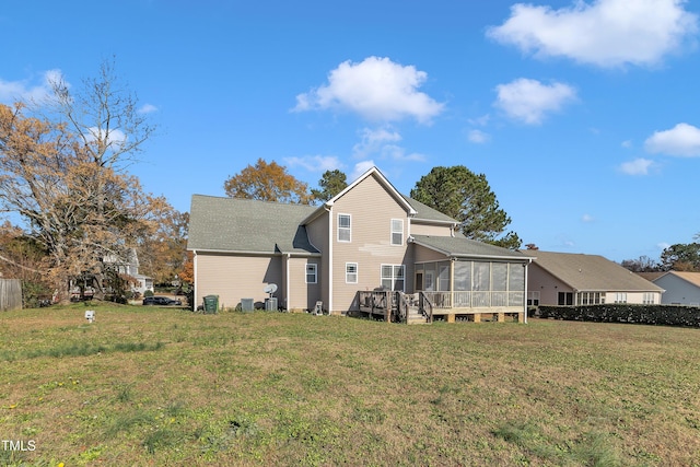 back of property featuring a lawn and a sunroom