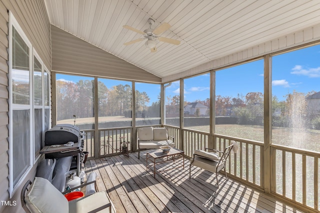 sunroom with ceiling fan and lofted ceiling