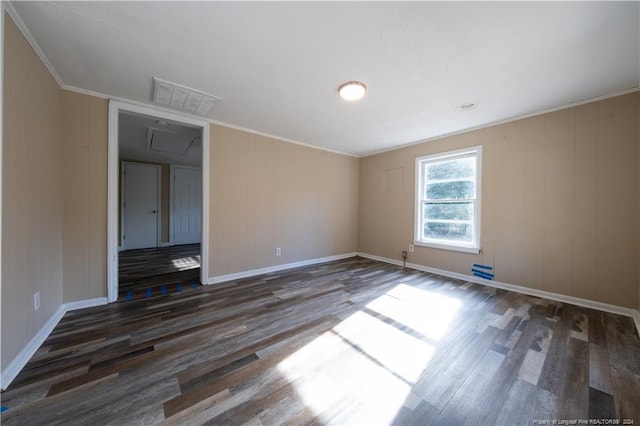 empty room featuring crown molding and dark hardwood / wood-style flooring