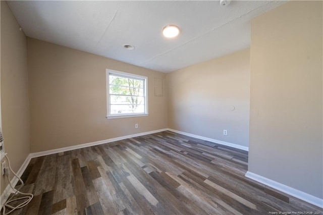 spare room with dark hardwood / wood-style flooring