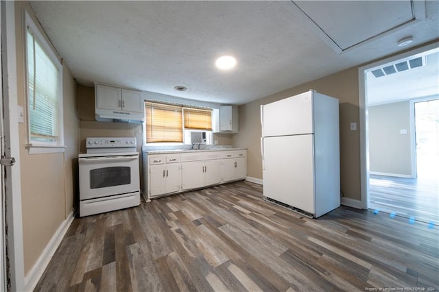 kitchen with white appliances, white cabinetry, a wealth of natural light, and dark wood-type flooring