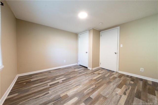 unfurnished bedroom with hardwood / wood-style flooring