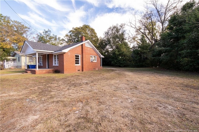 view of property exterior featuring a lawn and a porch