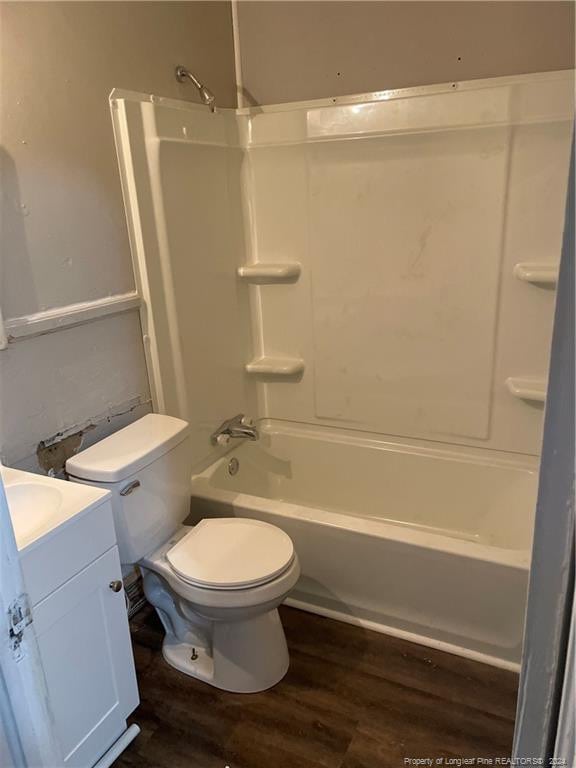 full bathroom featuring vanity, wood-type flooring,  shower combination, and toilet