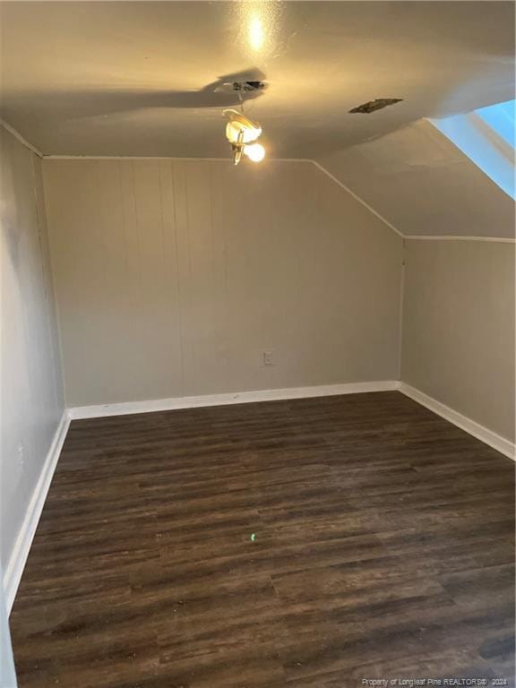 bonus room featuring dark hardwood / wood-style flooring and vaulted ceiling