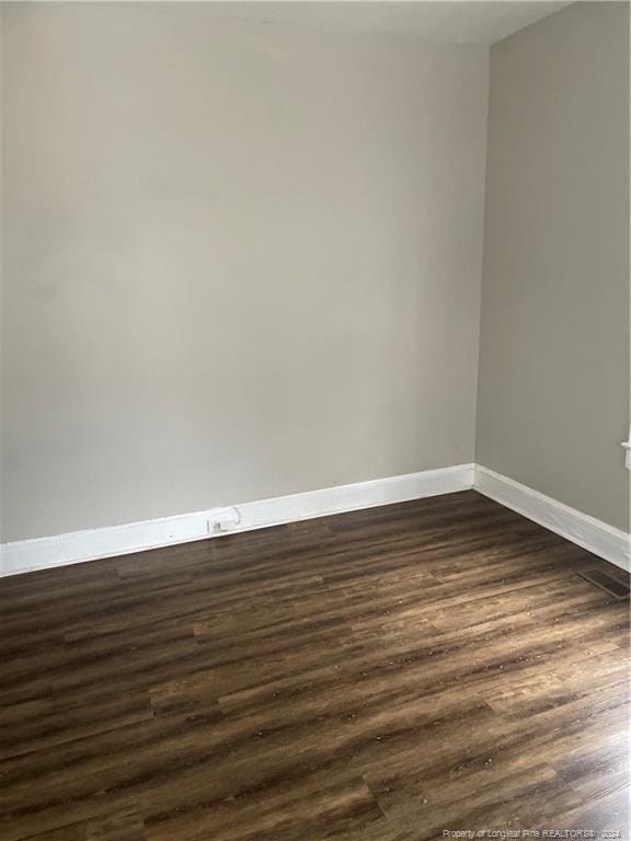 spare room featuring dark hardwood / wood-style flooring