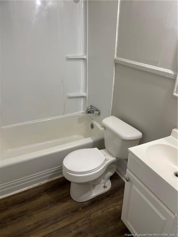 full bathroom with toilet, vanity, shower / bath combination, and hardwood / wood-style flooring