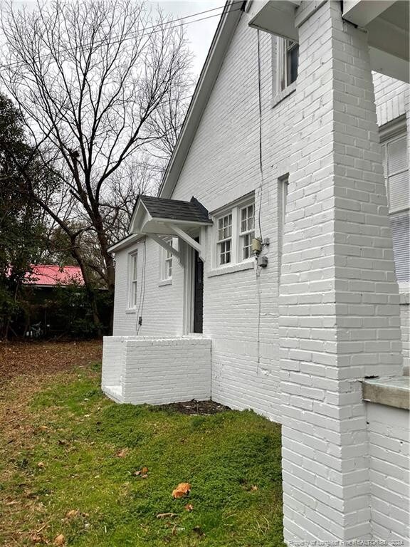 view of side of property with a lawn