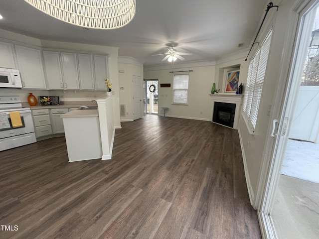 kitchen featuring sink, white appliances, white cabinetry, and dark hardwood / wood-style flooring