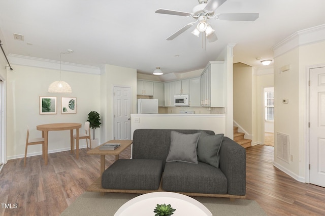 526 Elm Ave, Wake Forest, NC 27587 - living area featuring wood finished floors, baseboards, ceiling fan, ornamental molding, and stairway