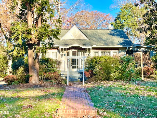 rear view of house featuring a yard