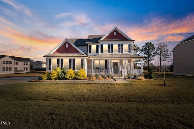 craftsman-style home featuring a porch and a lawn