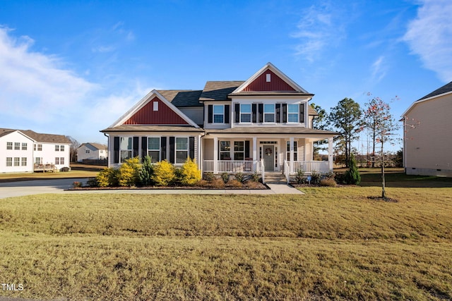 craftsman inspired home featuring a front lawn and covered porch