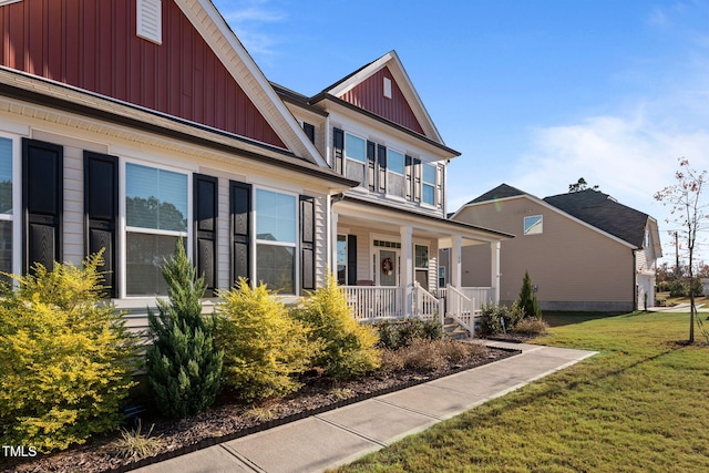 view of front of house with covered porch and a front yard