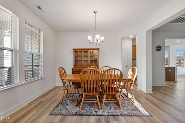 dining area featuring a chandelier and light wood-type flooring