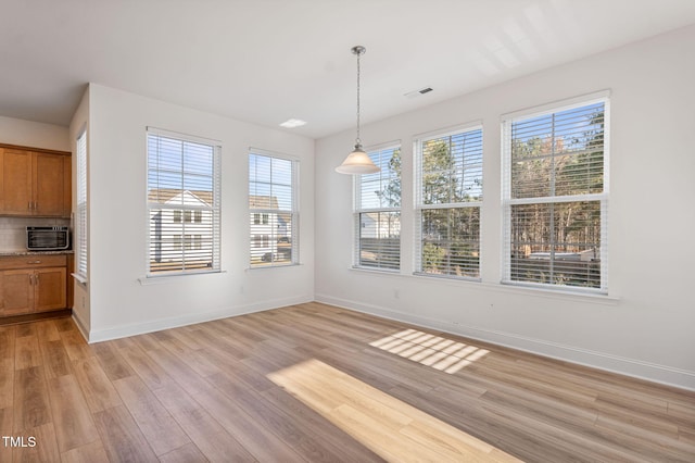 unfurnished dining area with light hardwood / wood-style flooring