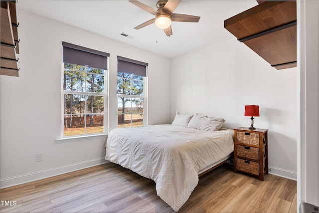 bedroom with ceiling fan and light hardwood / wood-style floors