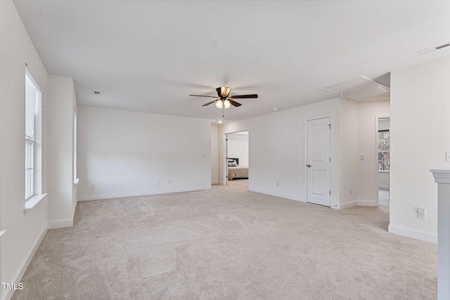 carpeted spare room with ceiling fan