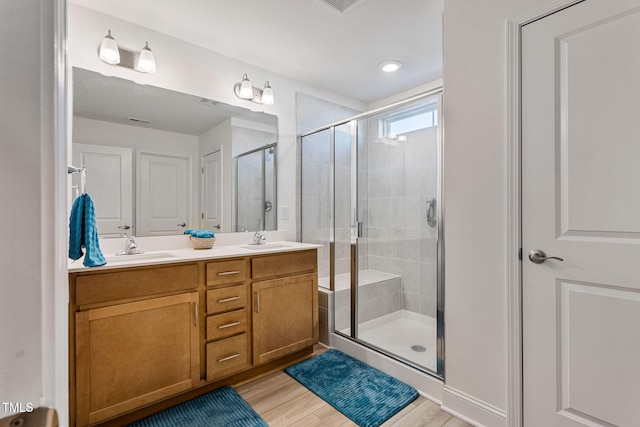 bathroom with vanity, hardwood / wood-style flooring, and walk in shower