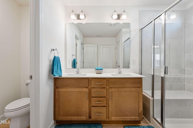 bathroom featuring walk in shower, vanity, and toilet