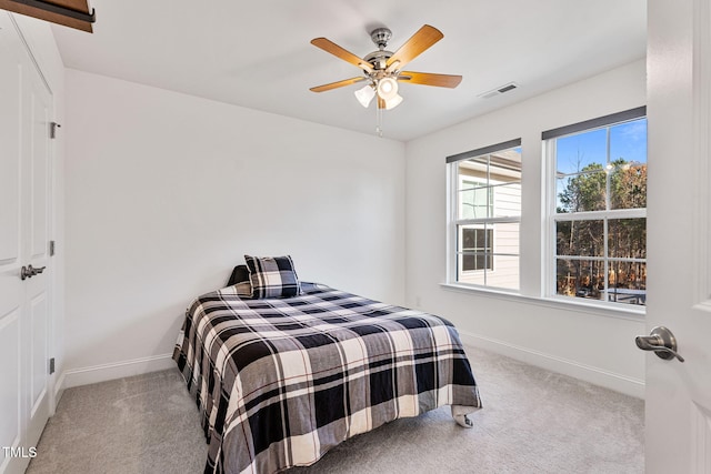 bedroom with ceiling fan and light colored carpet