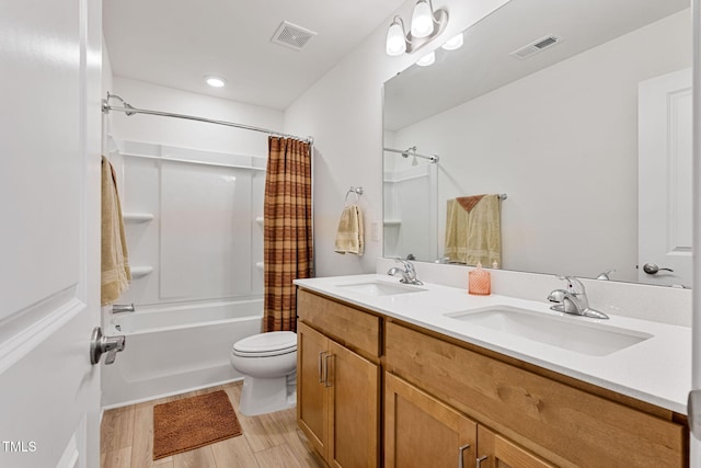 full bathroom featuring hardwood / wood-style flooring, vanity, toilet, and shower / bath combo