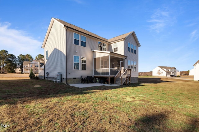 rear view of property with a sunroom and a yard