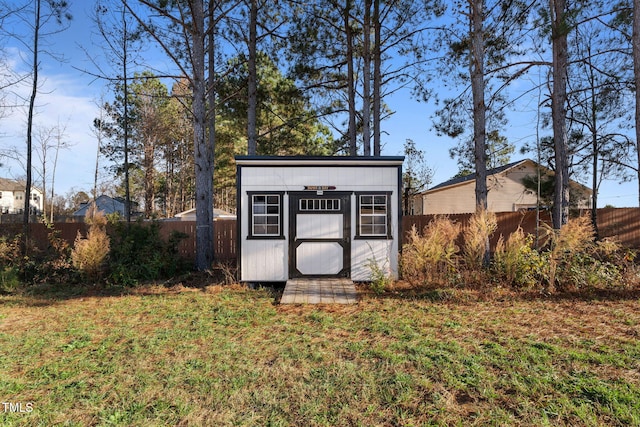 view of outbuilding featuring a lawn