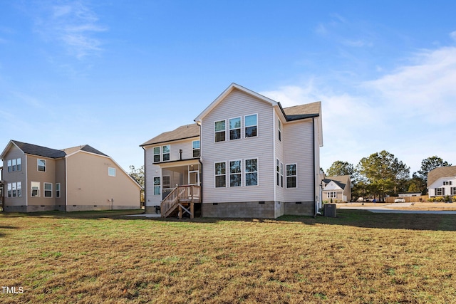 back of property featuring a yard and central AC unit