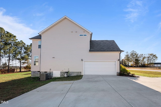 view of property exterior with a yard, a garage, and central AC unit