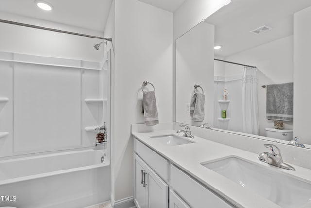 full bathroom with vanity, shower / tub combo, and toilet