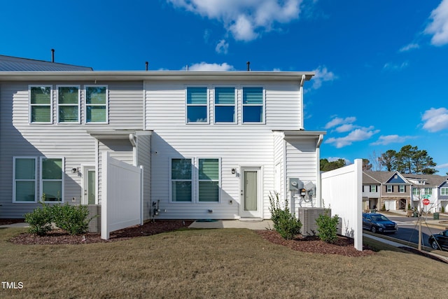 exterior space with central AC unit and a front yard