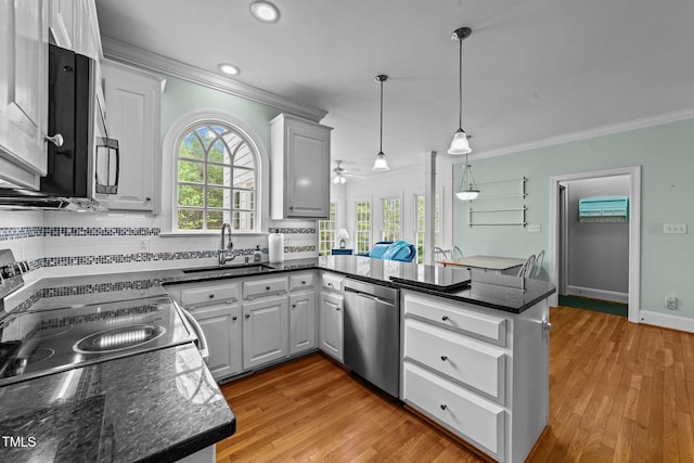 7201 Jonathan Dr, Wendell, NC 27591 - kitchen with ornamental molding, a peninsula, backsplash, dishwasher, and a sink