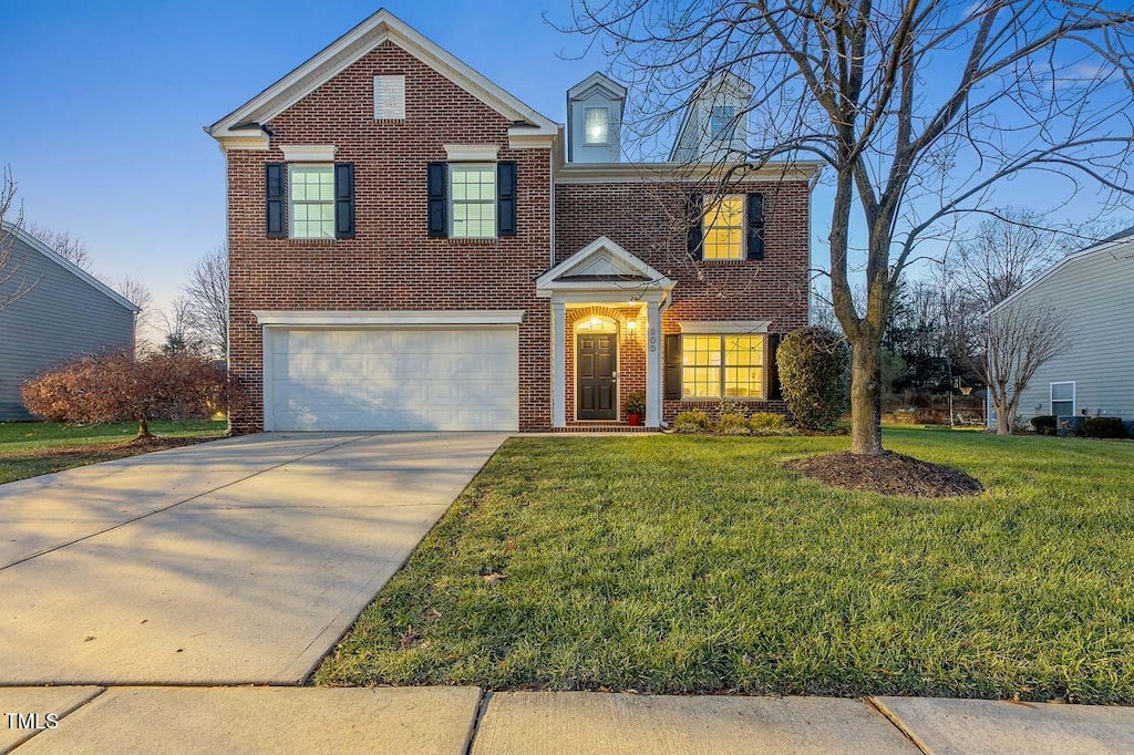 view of front of home featuring a front yard and a garage