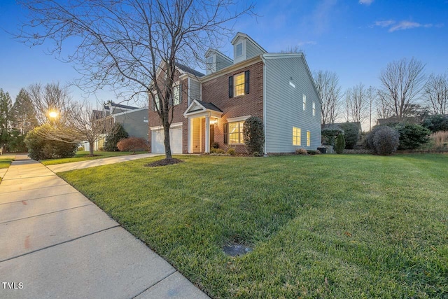 view of front facade with a lawn and a garage