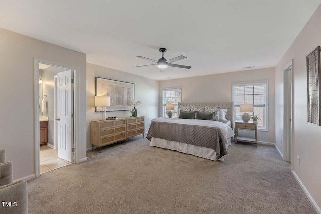 carpeted bedroom featuring ceiling fan and connected bathroom