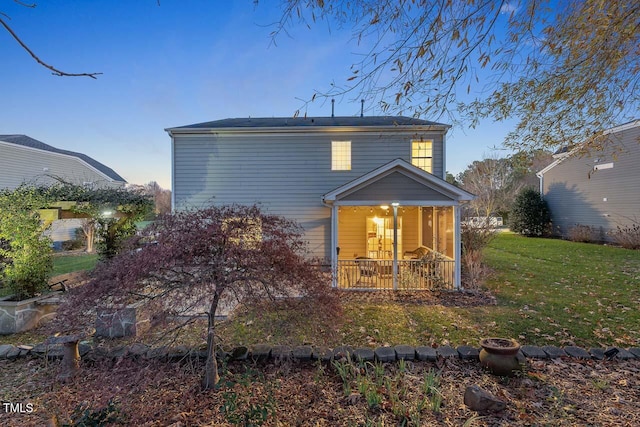 back of house featuring a lawn