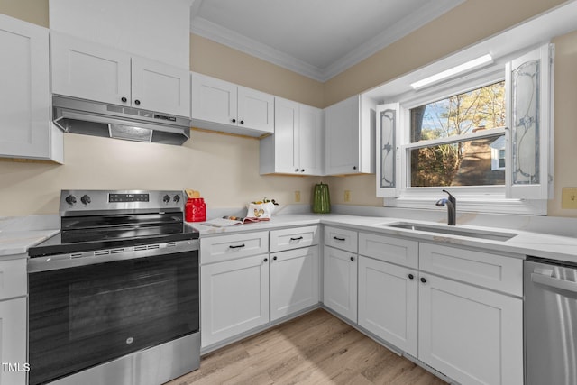 kitchen with stainless steel appliances, white cabinetry, sink, and crown molding