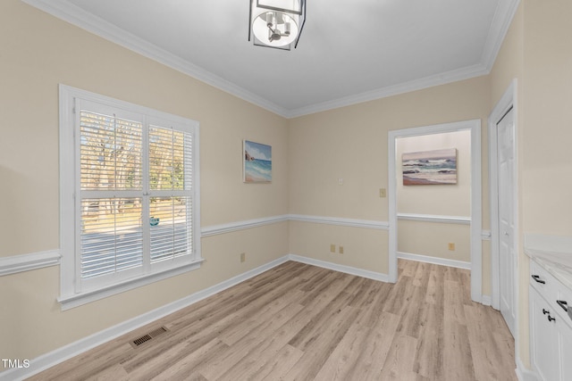 unfurnished dining area with light hardwood / wood-style floors and crown molding