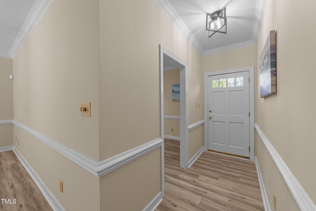 entryway with light hardwood / wood-style floors and crown molding