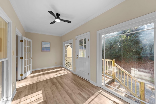 doorway to outside with ceiling fan, light wood-type flooring, and crown molding