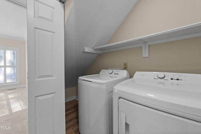 laundry area featuring wood-type flooring and separate washer and dryer