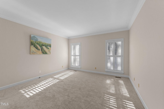 carpeted spare room featuring a wealth of natural light and crown molding