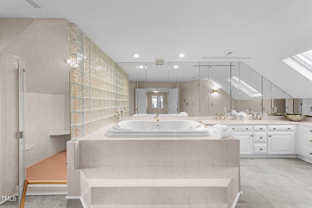 bathroom featuring a textured ceiling, walk in shower, vanity, and tile patterned floors