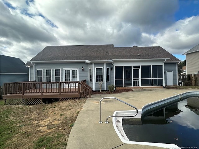 back of house with a pool side deck, a sunroom, and a patio