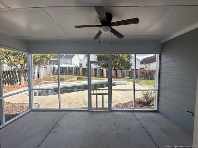 unfurnished sunroom with ceiling fan and a wealth of natural light