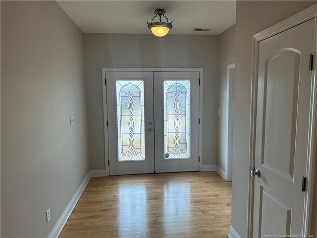 entryway with light hardwood / wood-style flooring and french doors